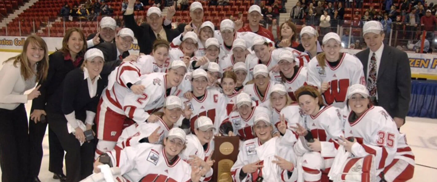 The 2005-06 women's hockey team celebrates with the national championship trophy.