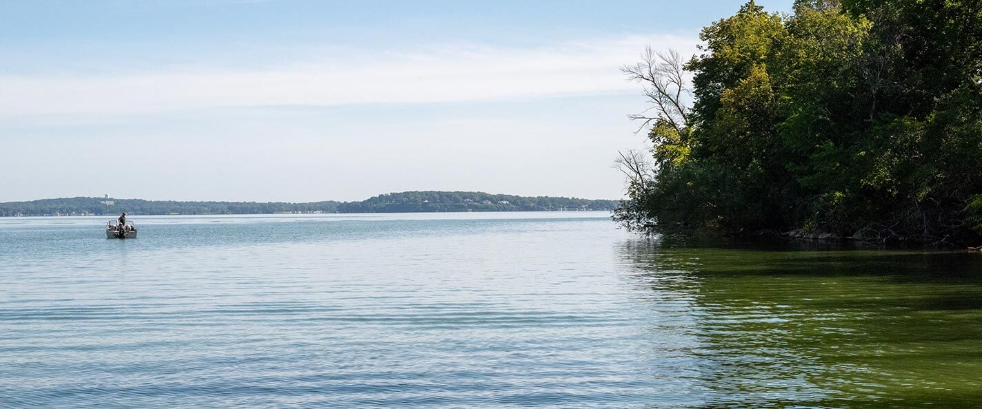 A shot of Lake Mendota with a small boat in the distance. 