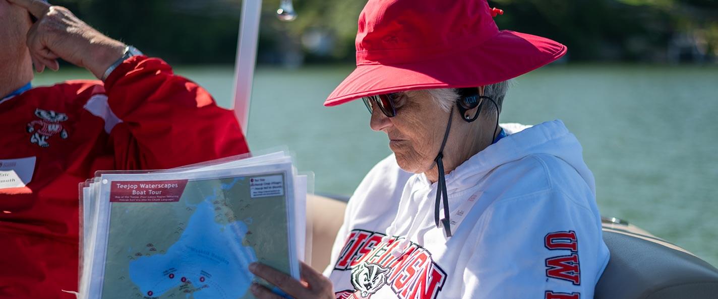 Members flip through visual aids during boat tour.